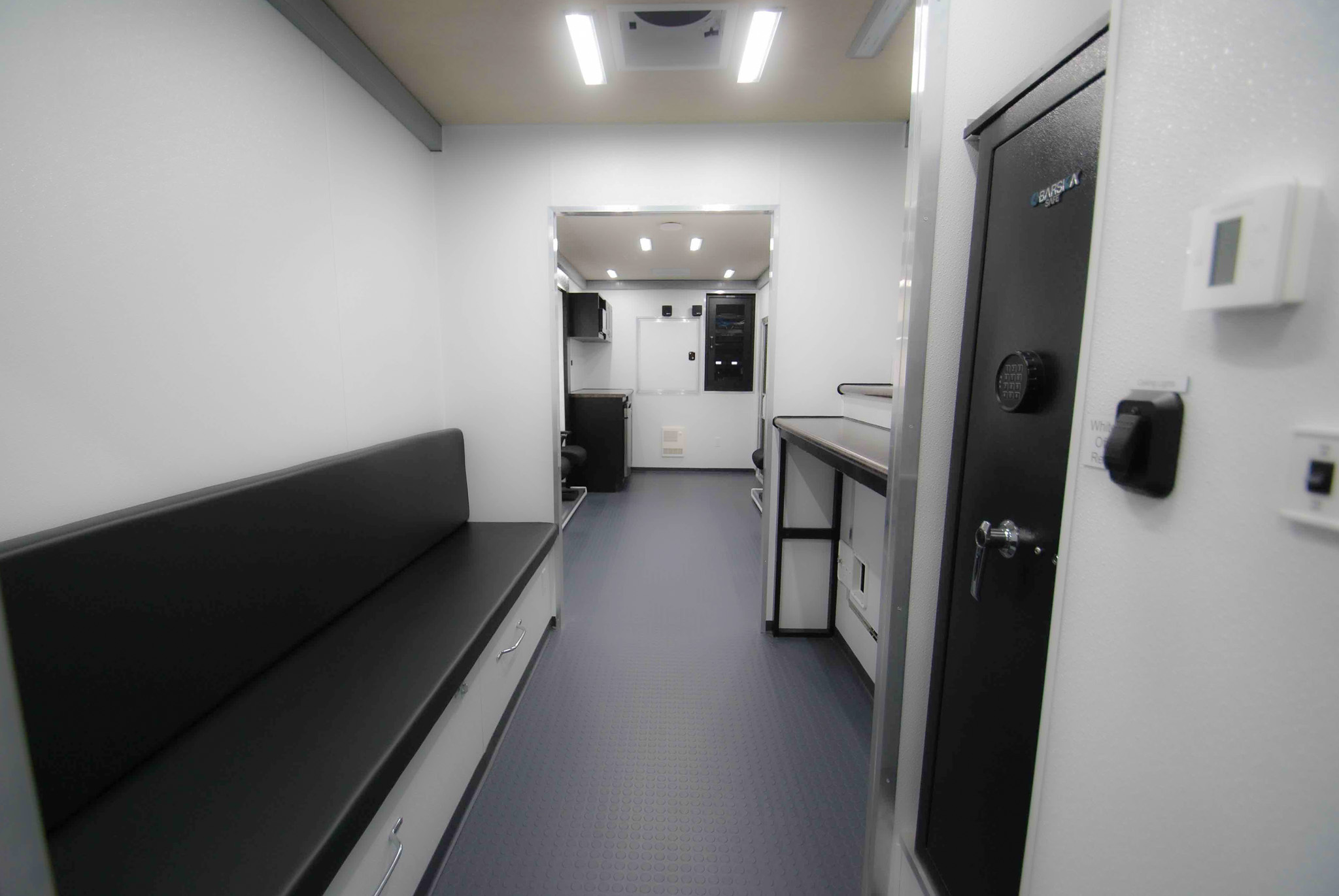 The interior of Atlanta Border Patrol's unit showcasing bench seating, a desk, and a server cabinet.