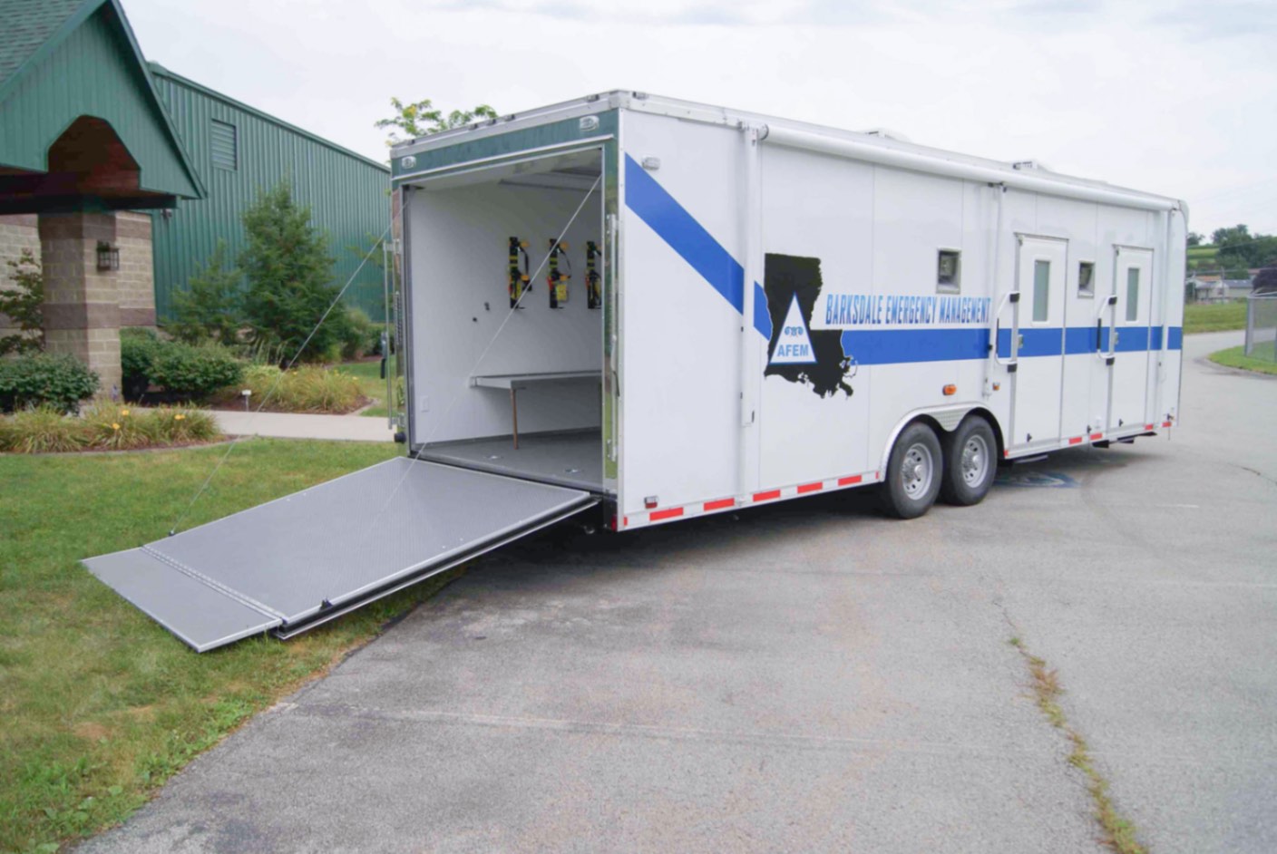 An exterior view of the CBRNE Response Trailer made for the Barksdale AFB in LA. The rear ramp door is down.
