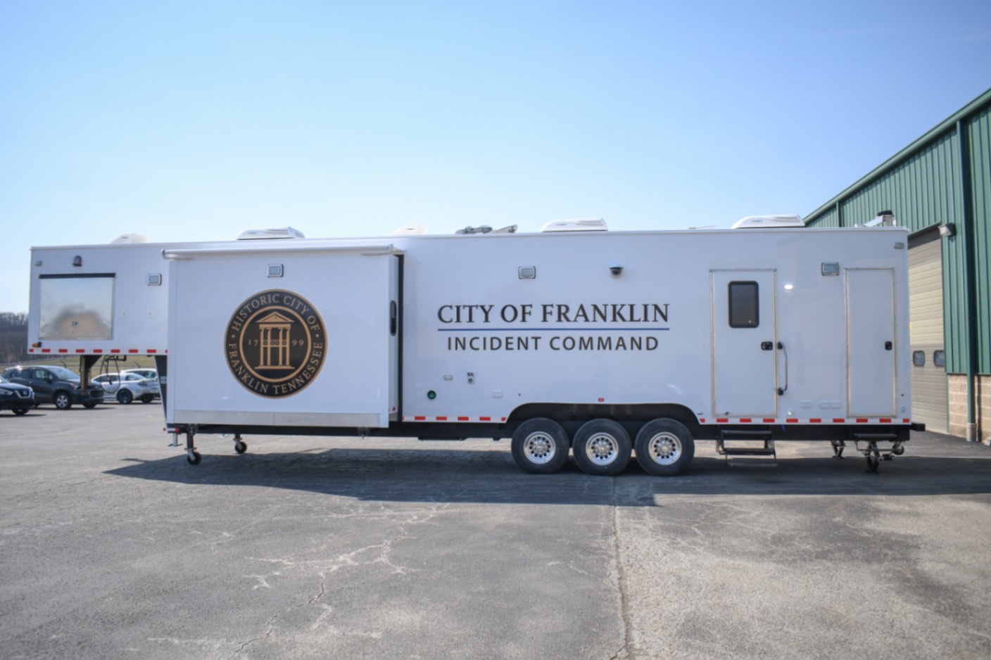 An alternate side view of the Command 42-7WS FW 2SO made for Franklin, TN. The slideouts are deployed.