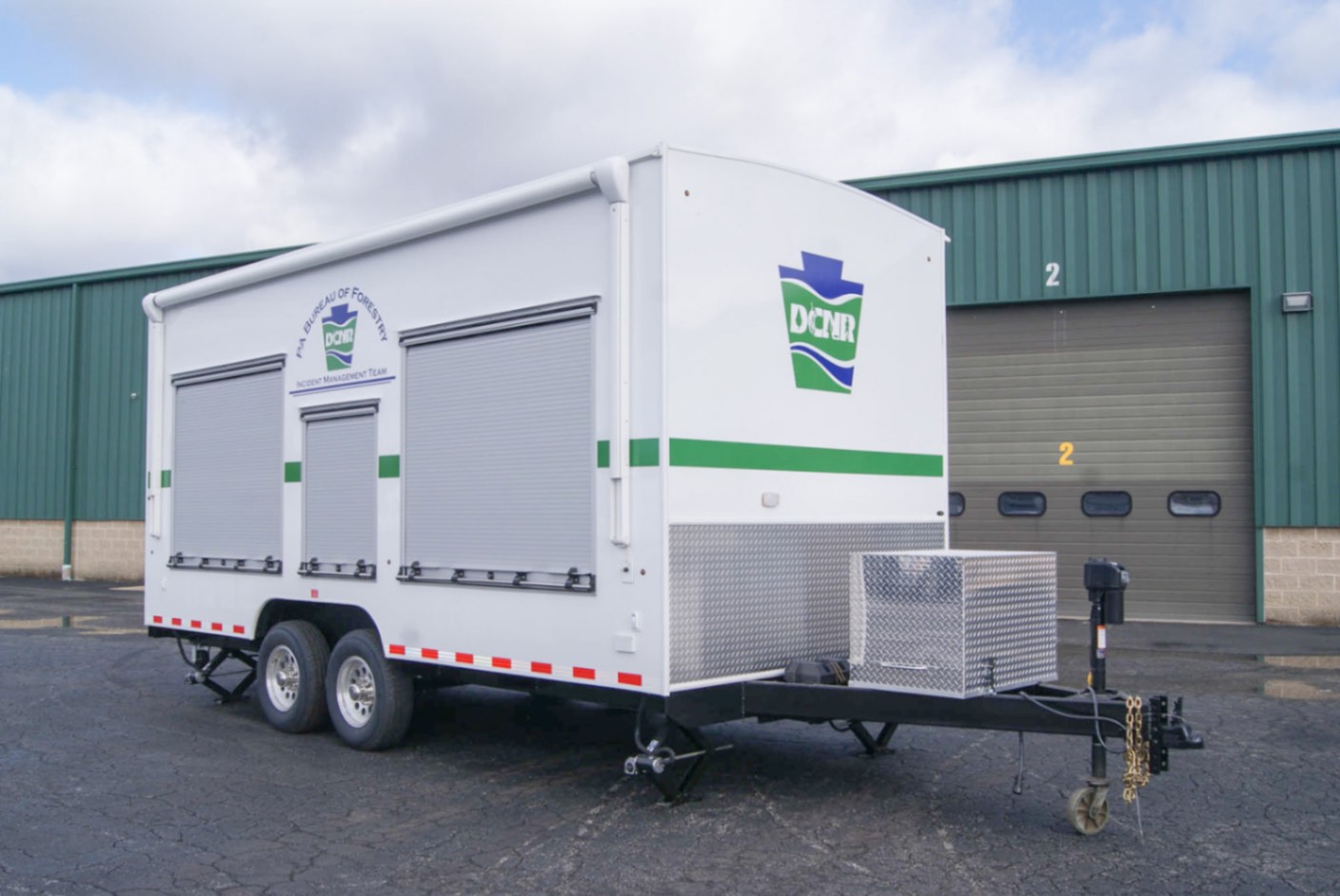 An exterior view of the upfitted Drone Observation Command trailer made for the PA DNCR. The roll-up doors are down.