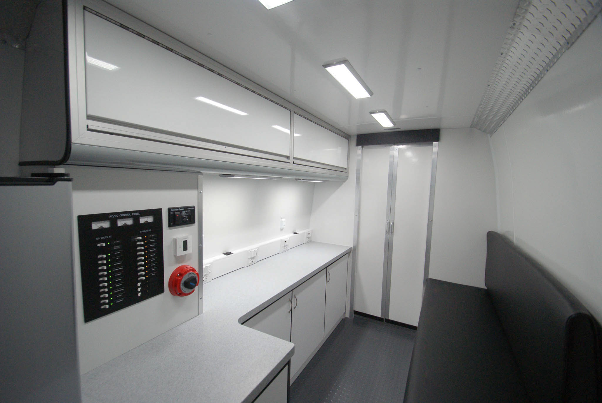 An angled view of the Mobile Outreach sprinter van's back room as seen from the rear entrance.