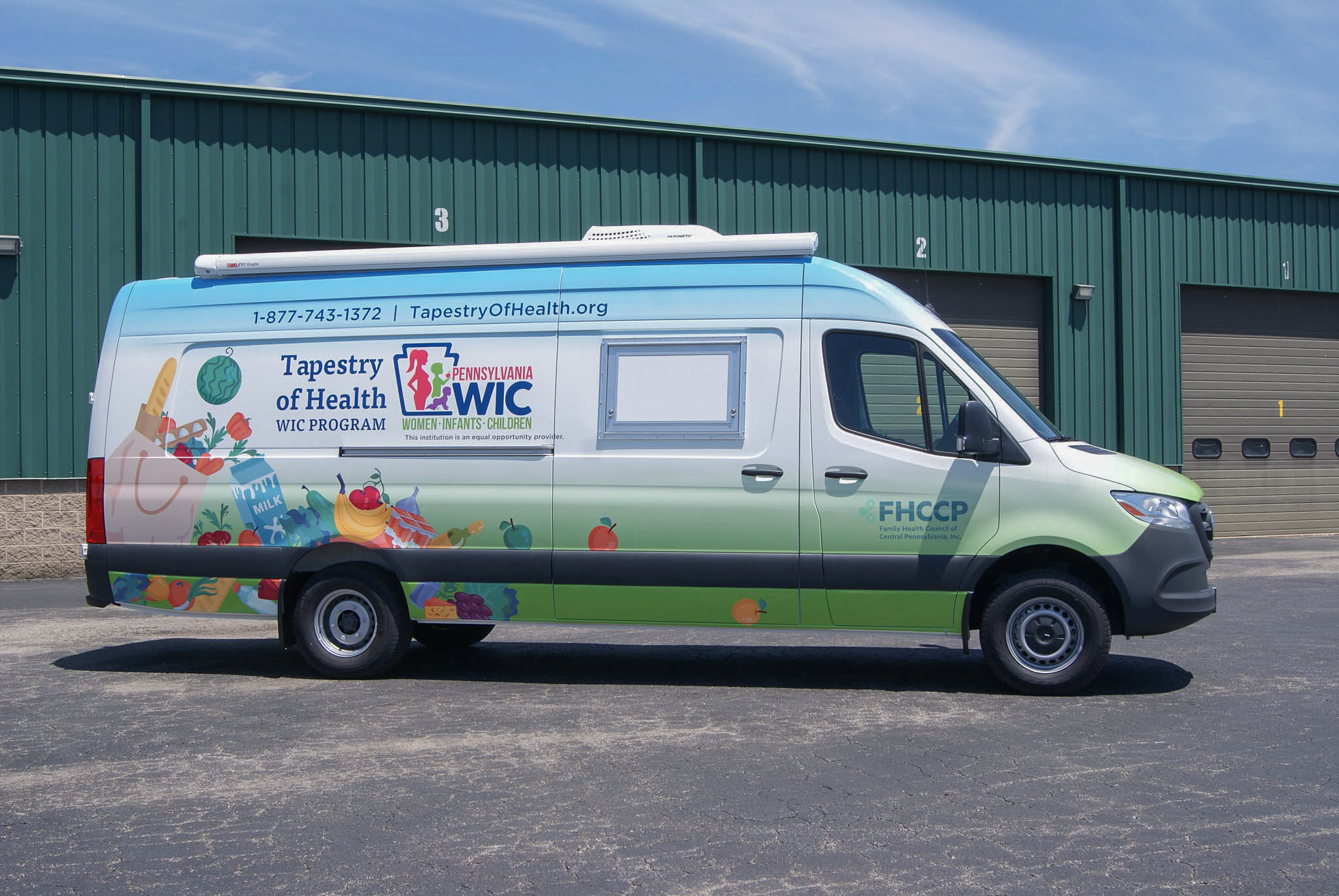 Direct side view of the Mobile Outreach sprinter van. It features the logo for Tapestry of Health's WIC program, their phone number, and their website.