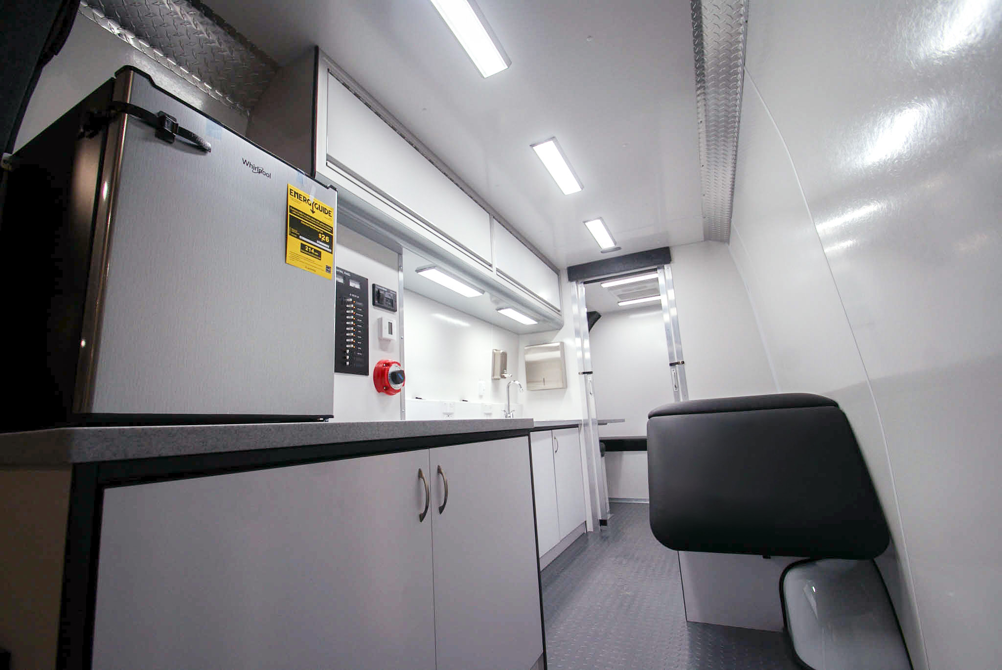 An angled view of the Mobile Medical Exam sprinter's back room as viewed from the rear entrance.