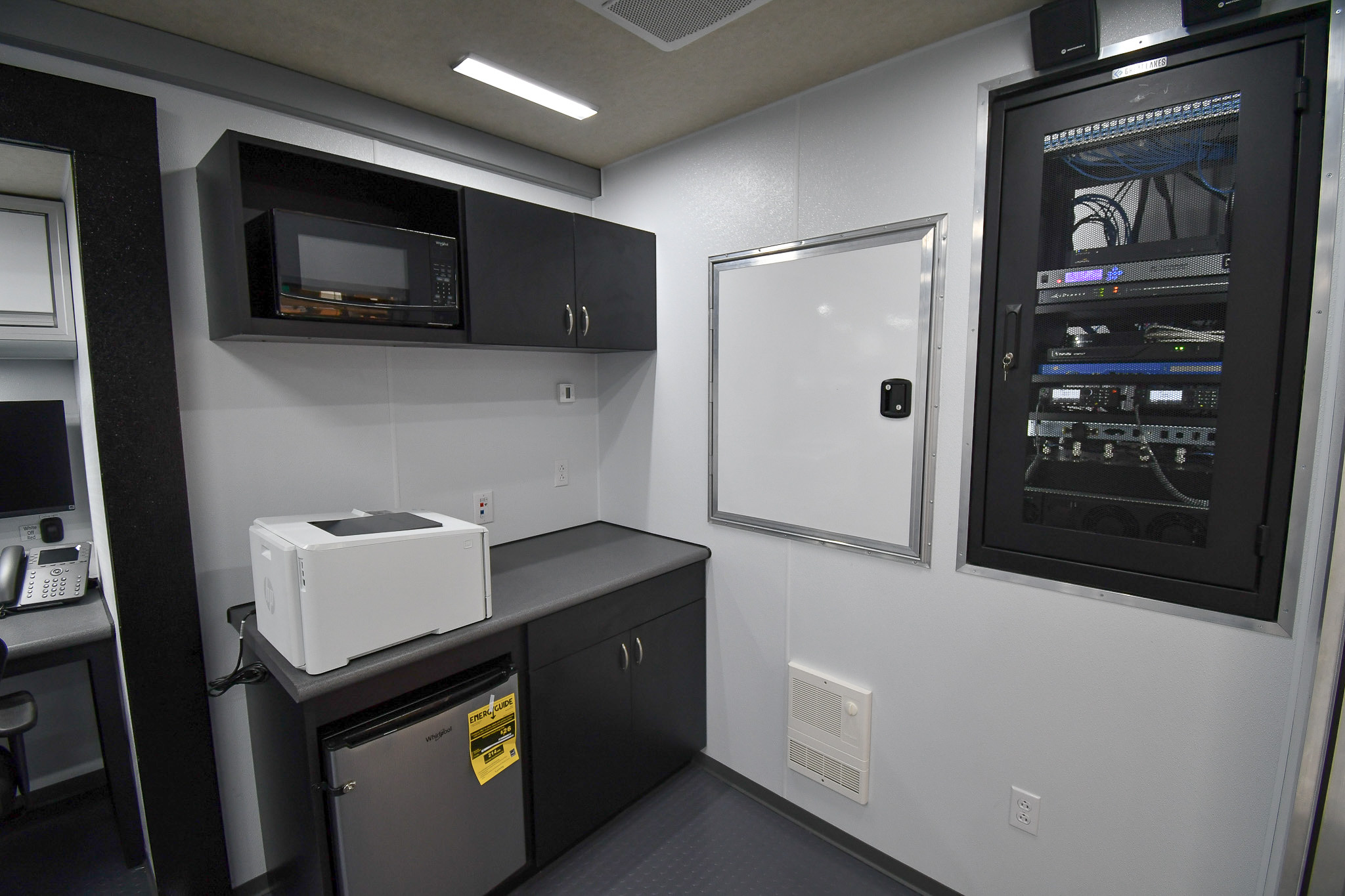 The kitchenette/office area and electronics rack cabinet inside the unit for New Orleans, LA.