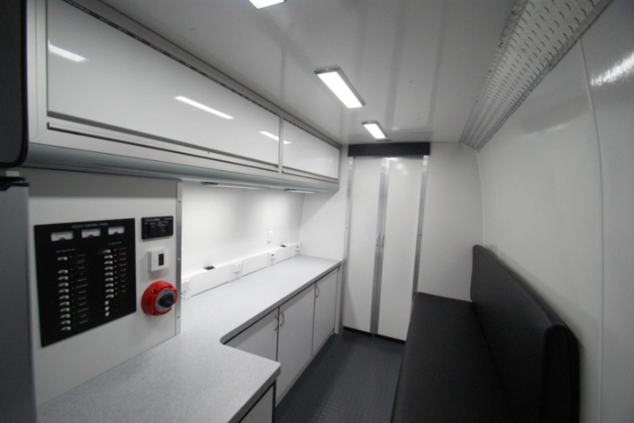 A back-to-front view inside the Outreach Sprinter van made for Camp Hill, PA. The door to the waiting area is closed.