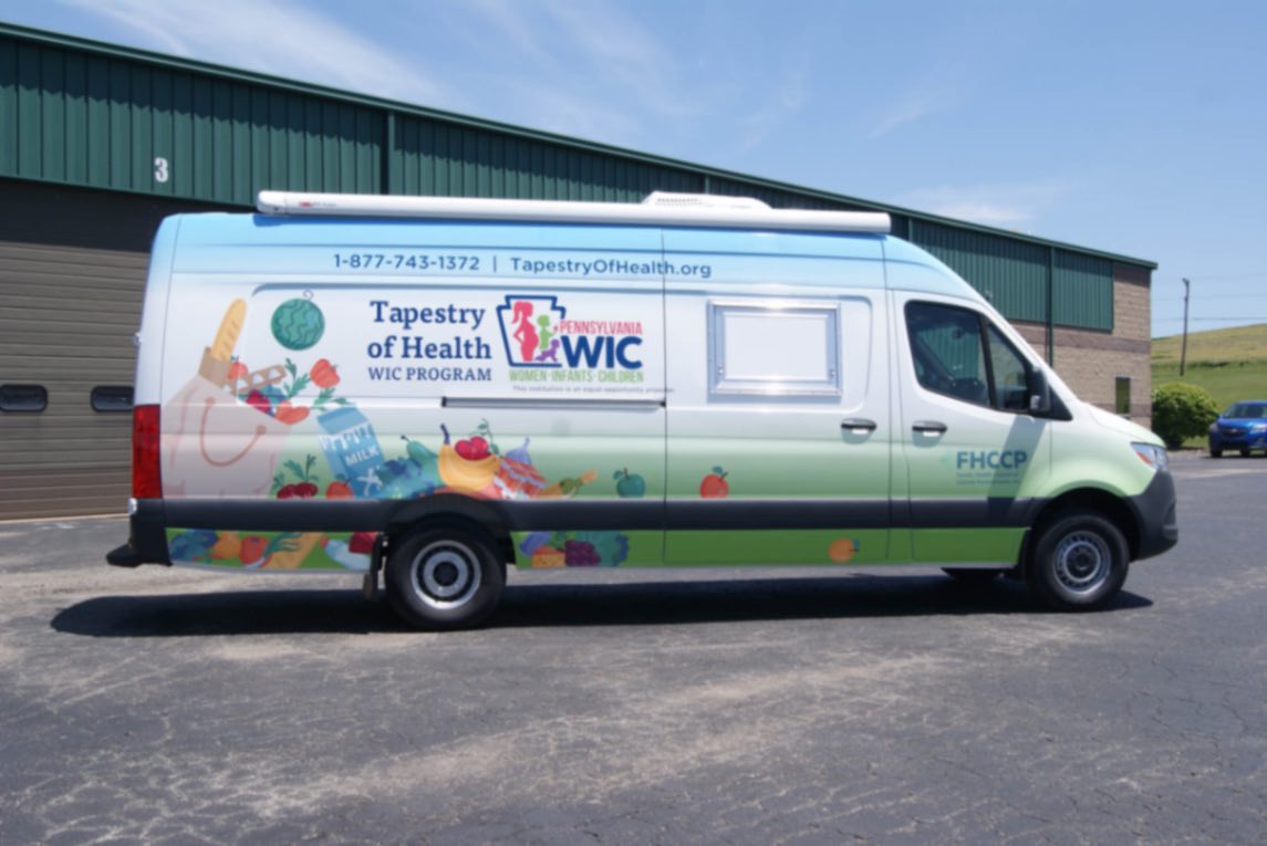 A side view of the Outreach Sprinter van made for Camp Hill, PA.