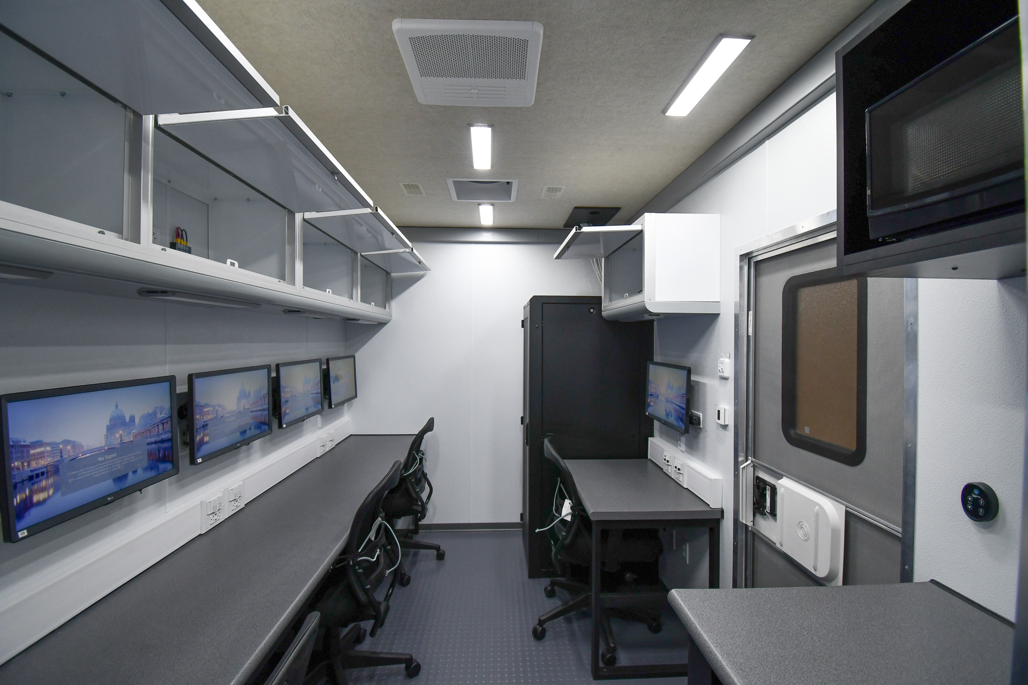 A view of the three workstations, kitchenette, and electronics rack cabinet inside the unit for Montgomery County, TN.