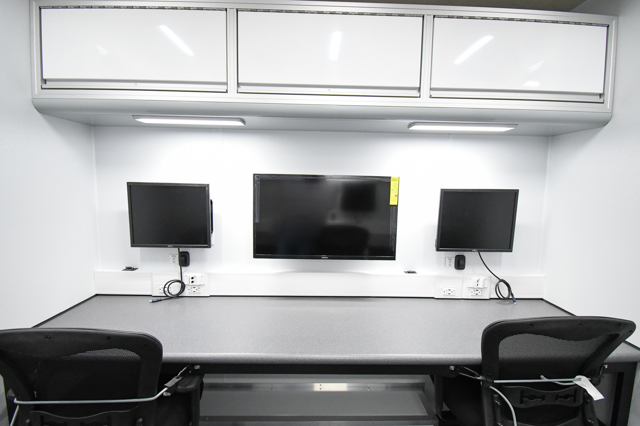 A view of the monitors for 2 workstations inside the unit for Caribou, ME.