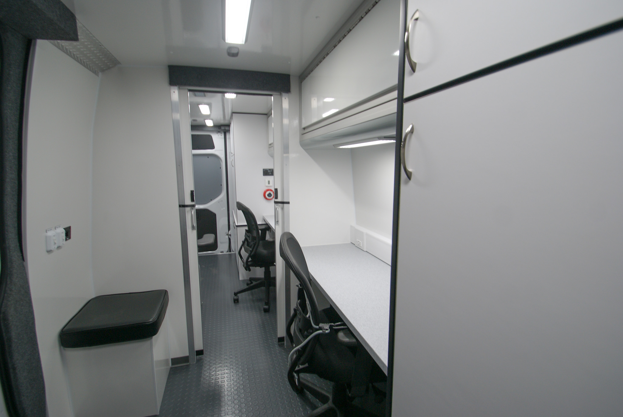 Interior view of the workstation, cabinet, seat, and clinic area inside the units made for Talledaga, AL.