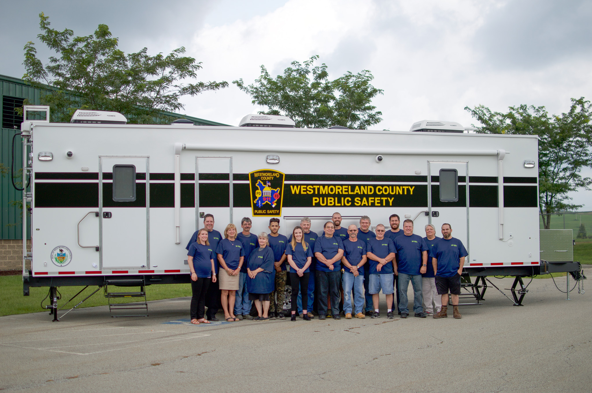 Westmoreland County Public Safety Staff members standing in front of their new trailer.