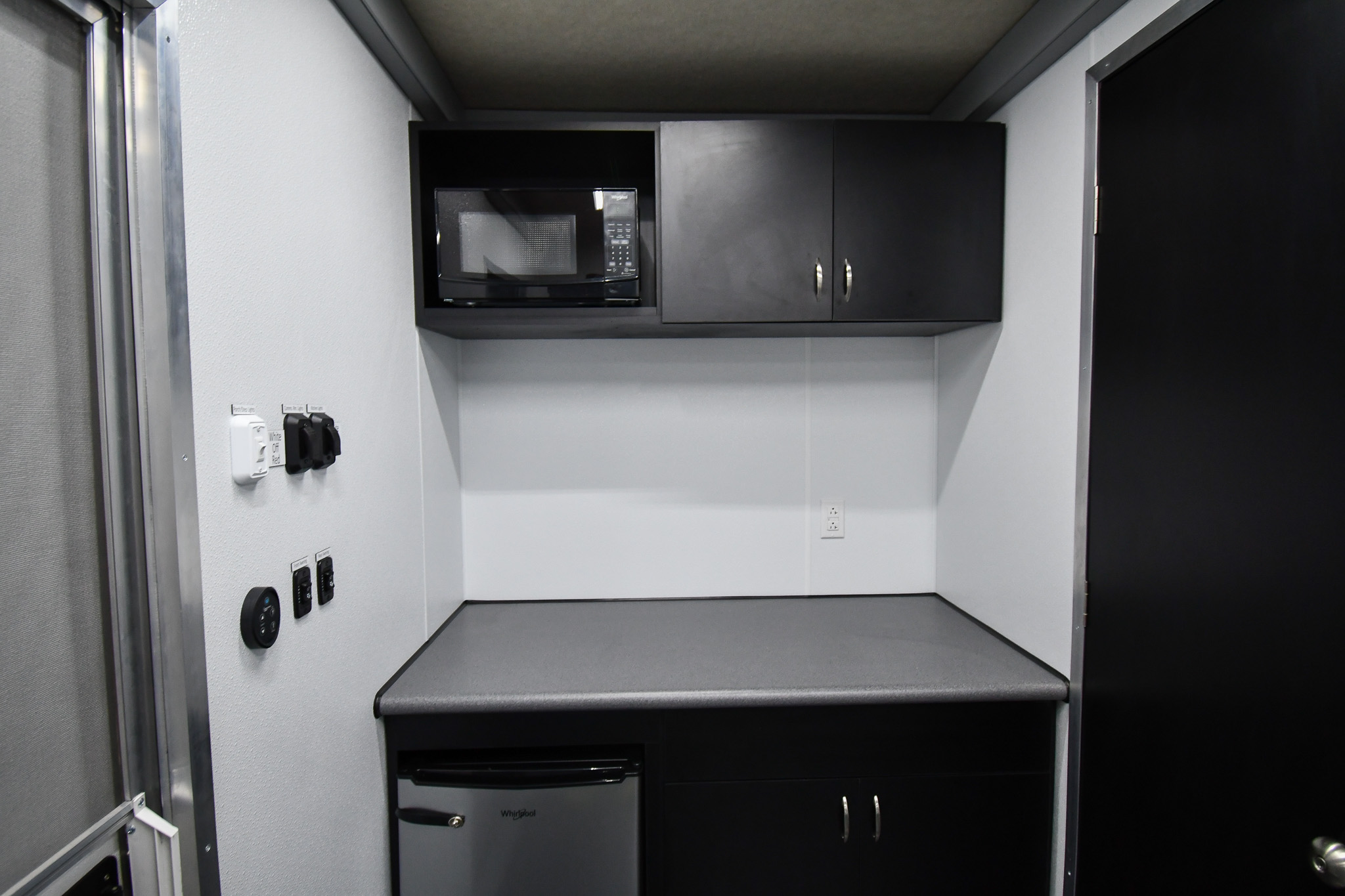 The kitchenette and closed door leading to the bathroom inside the unit for CBP in Puerto Rico.