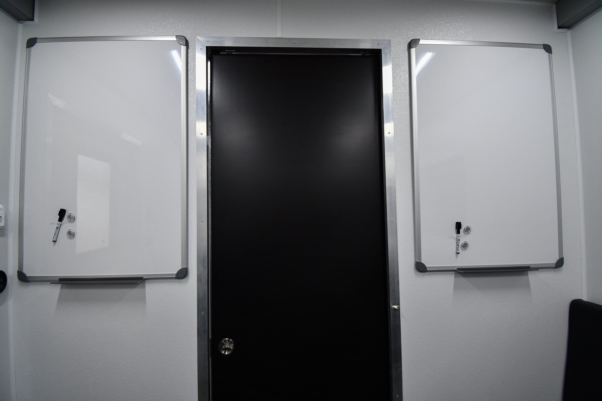 The mounted whiteboards in the conference room inside the unit for CBP in Puerto Rico.