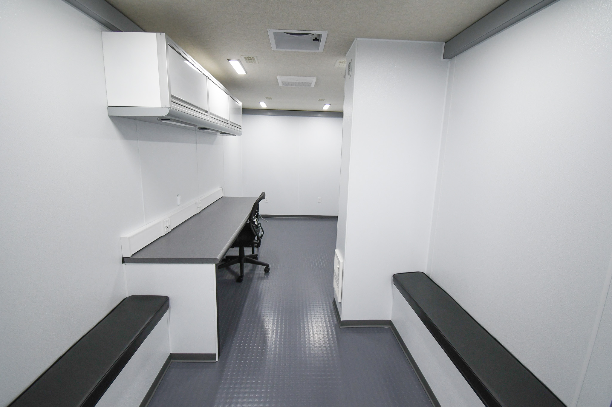 A view of both padded benches to the left of the workstation inside the unit for Hot Springs, AR.