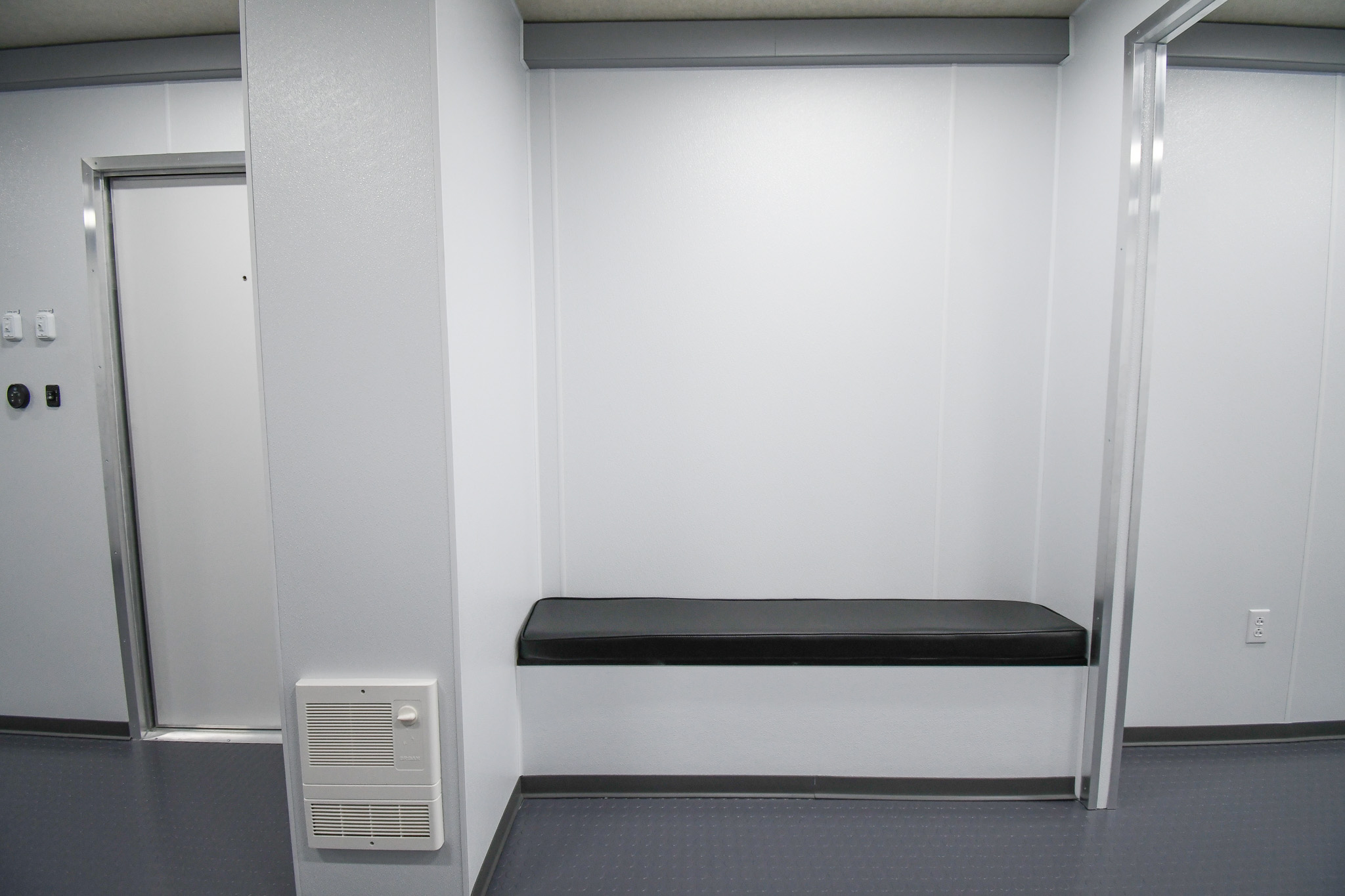 A view of the padded bench to the left of the workstation inside the unit for Hot Springs, AR.