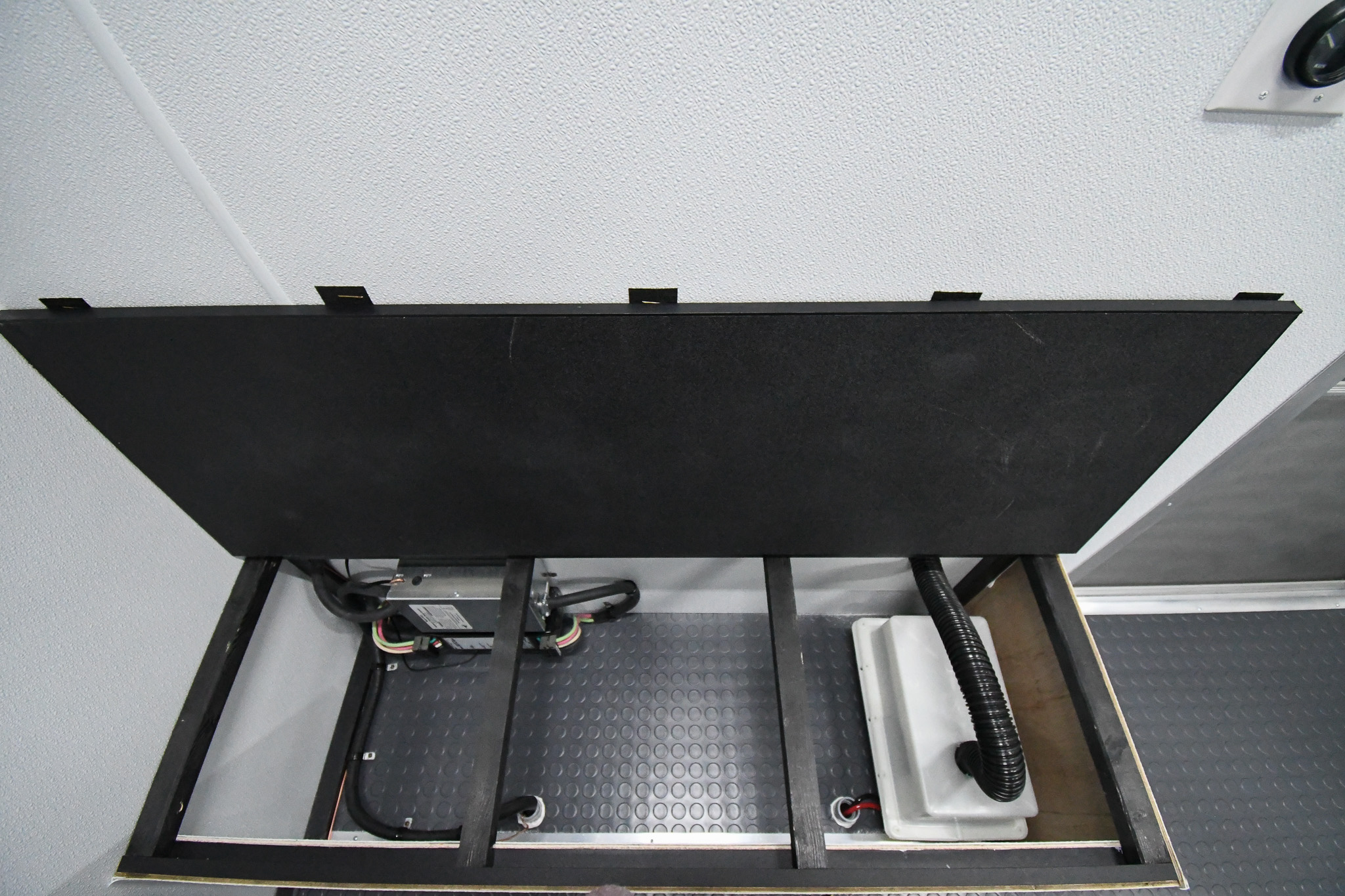 The storage area beneath one of the conference room benches inside the unit for Richland County, MT.