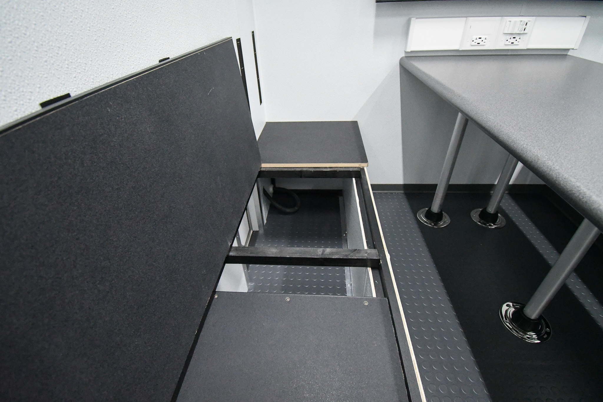 The storage area beneath one of the conference room benches inside the unit for Richland County, MT.