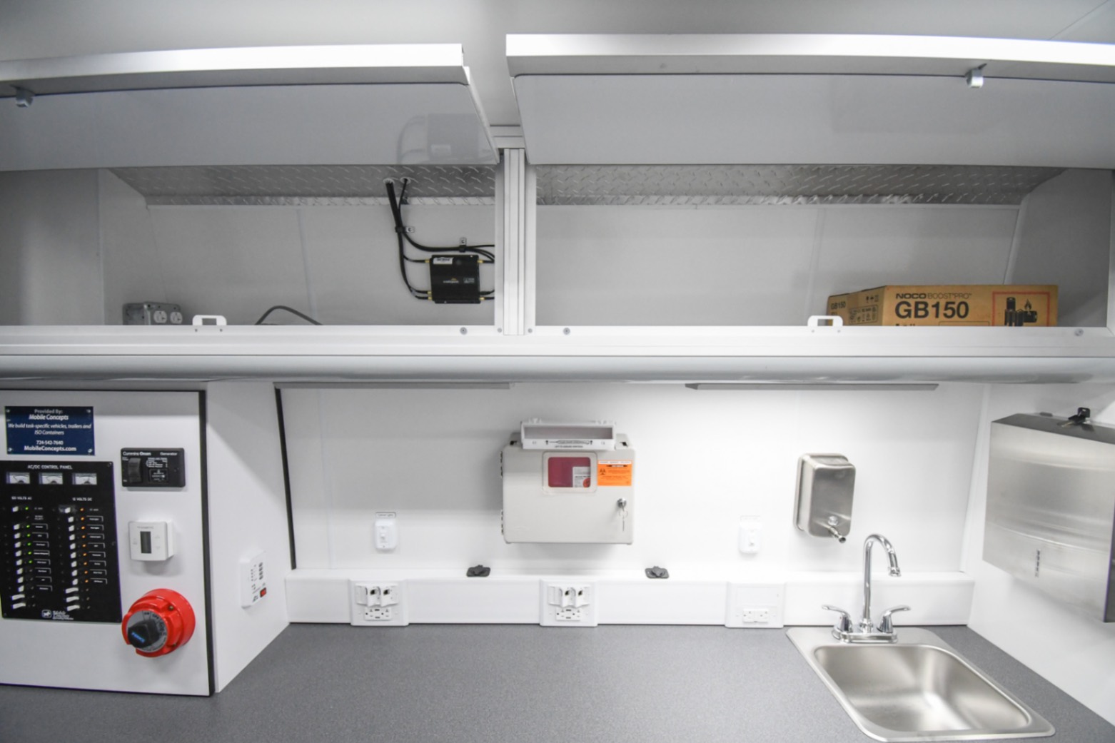An interior view of the Medical Exam sprinter made for Lancaster, PA. The overhead cabinets are open.