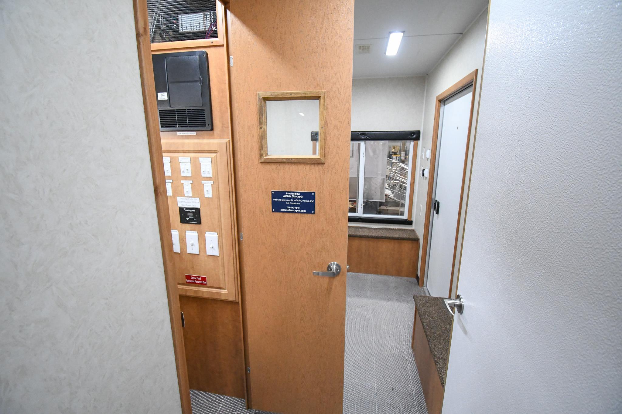 A front-to-back interior view of the unit for Chiloquin, OR. It starts at the door to the bedroom stage. The door to the control room is open.