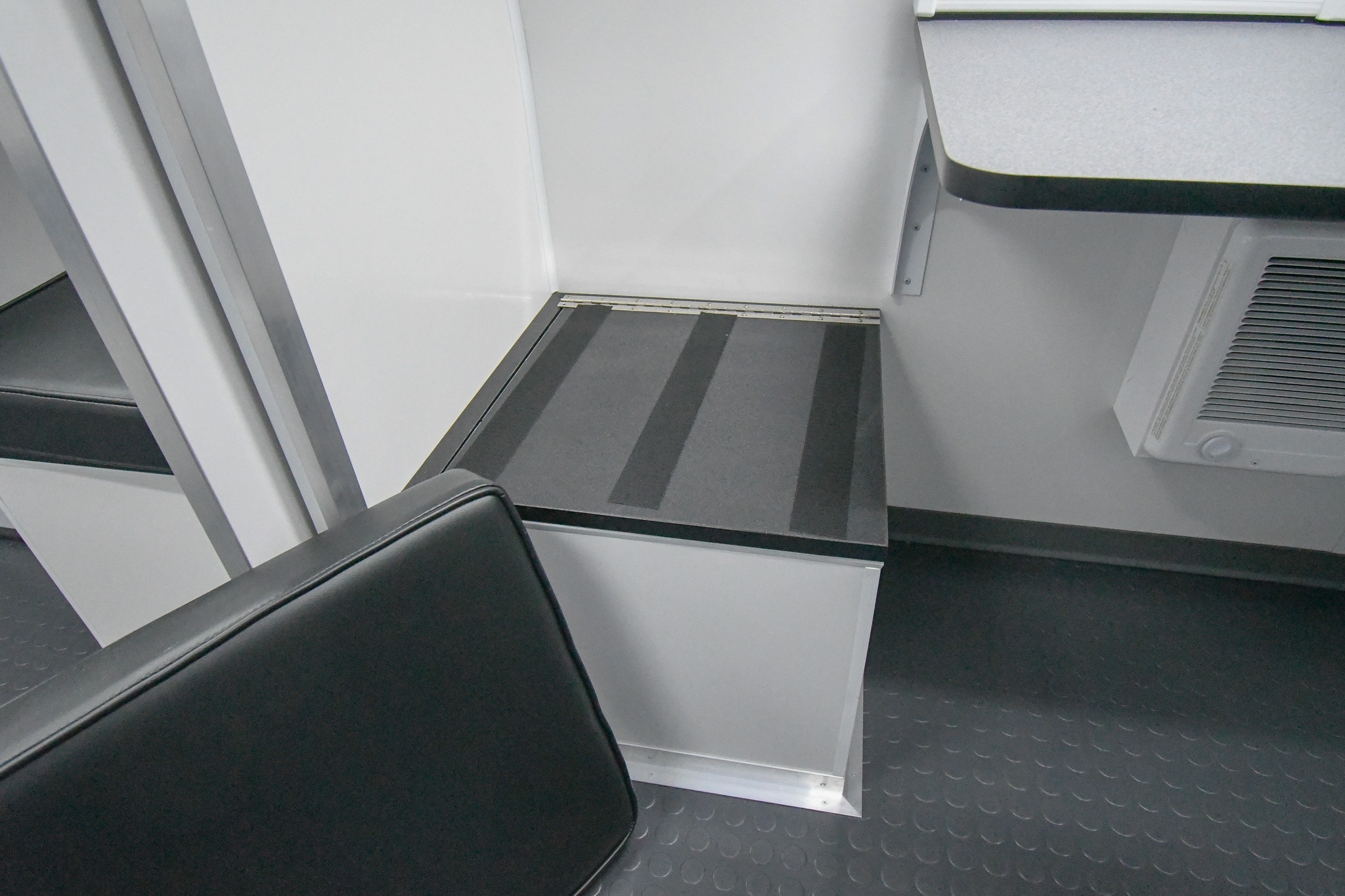 A hinged bench inside the unit for Crescent City, CA.