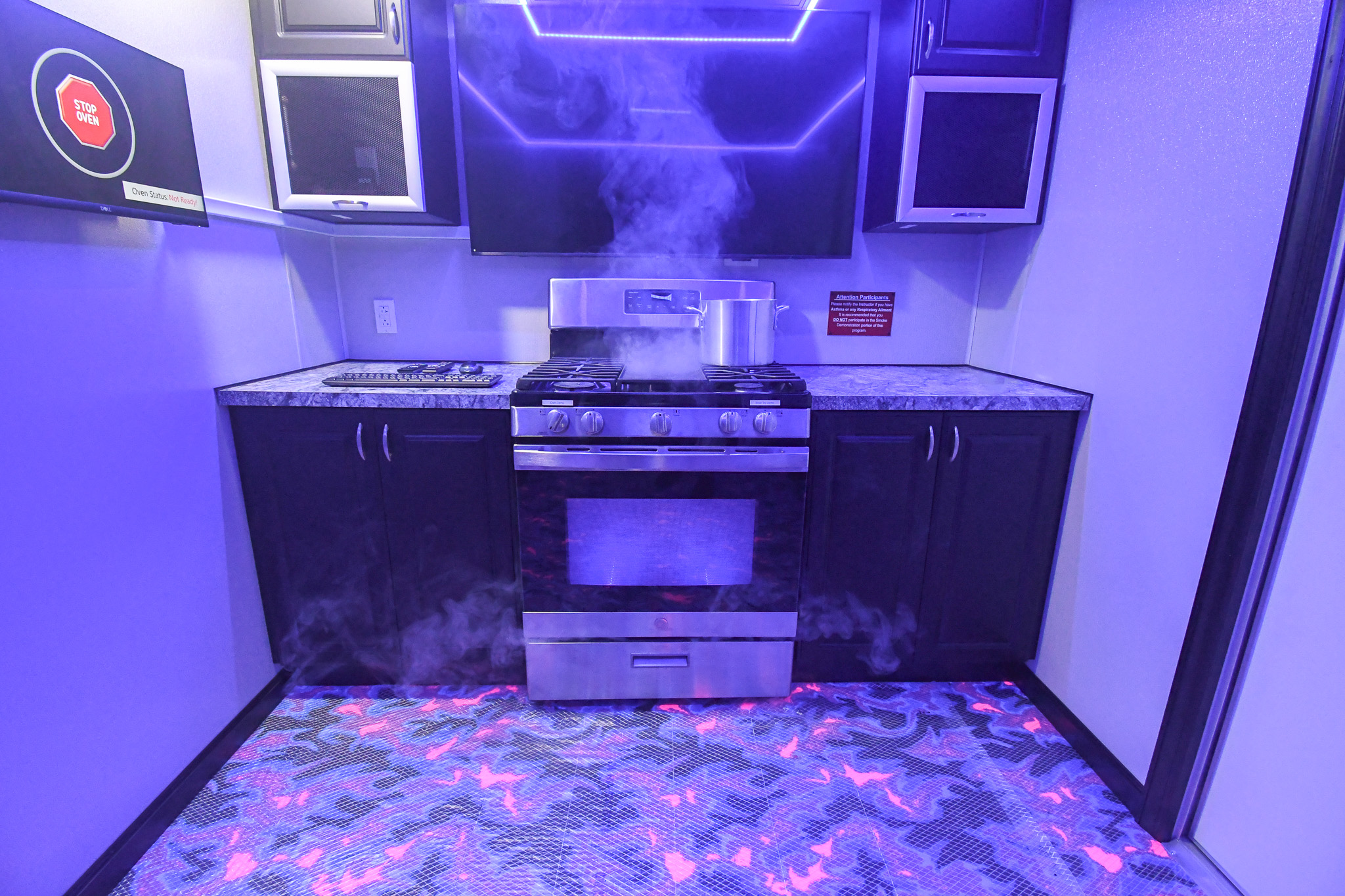The kitchen stage inside the unit for Bullhead City, AZ. The stovetop and oven door are emitting haze.
