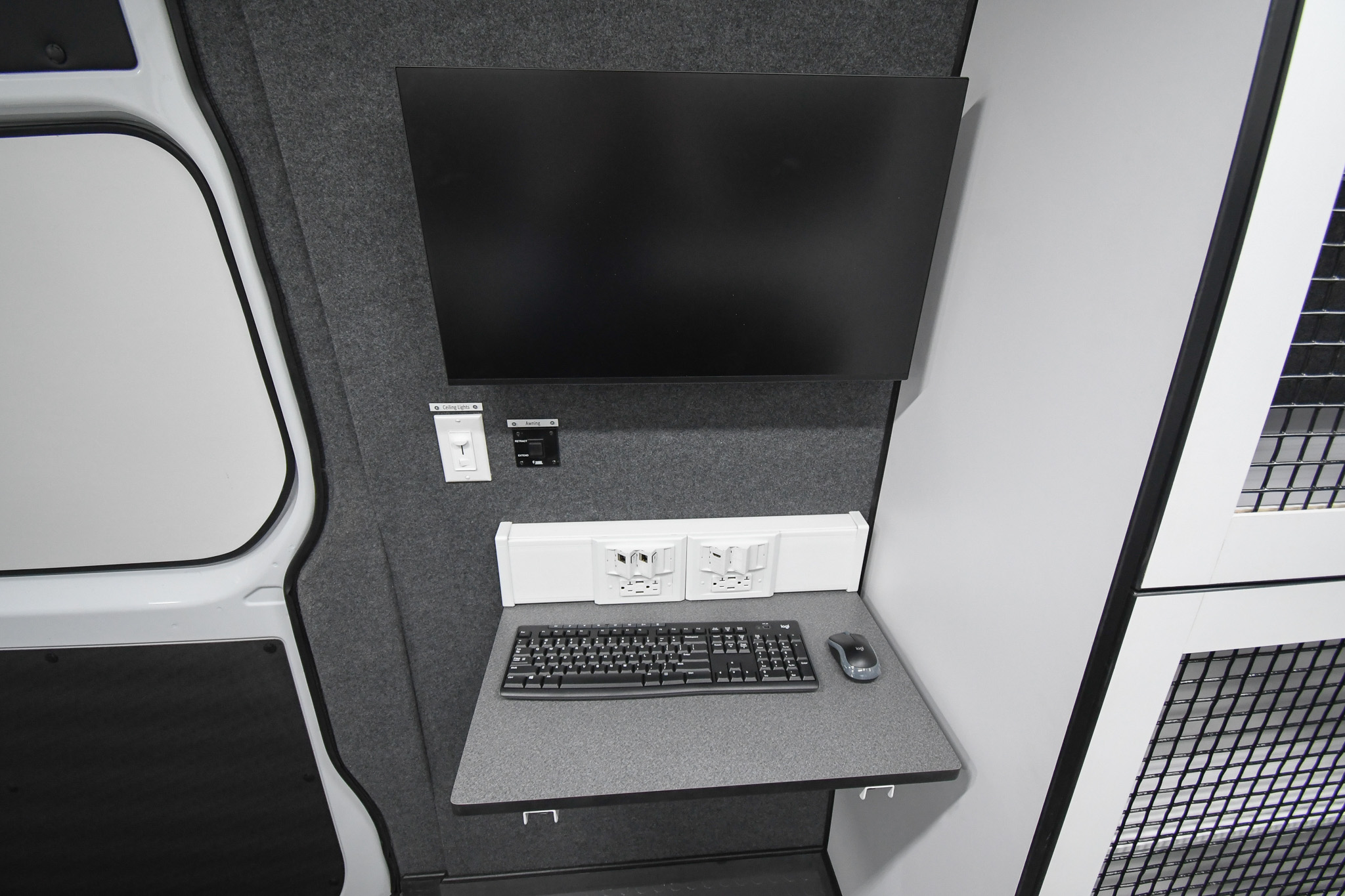 The fold-up desk with a monitor inside the unit for Jackson, MS.
