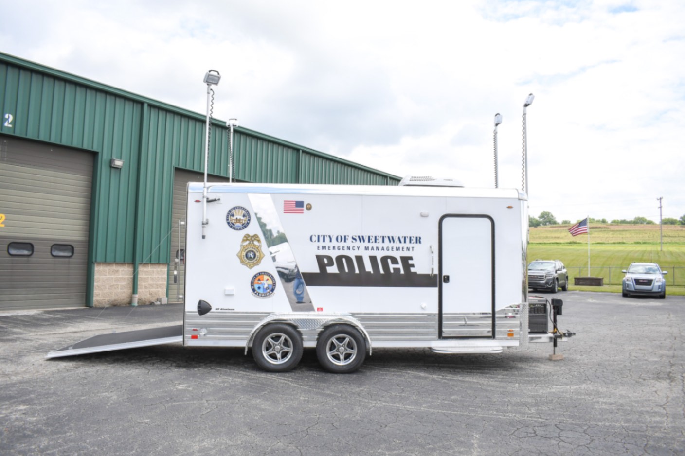 A side view of the Command 20 Cargo Supply trailer made for Sweetwater, FL. The push-up pole lights are up.