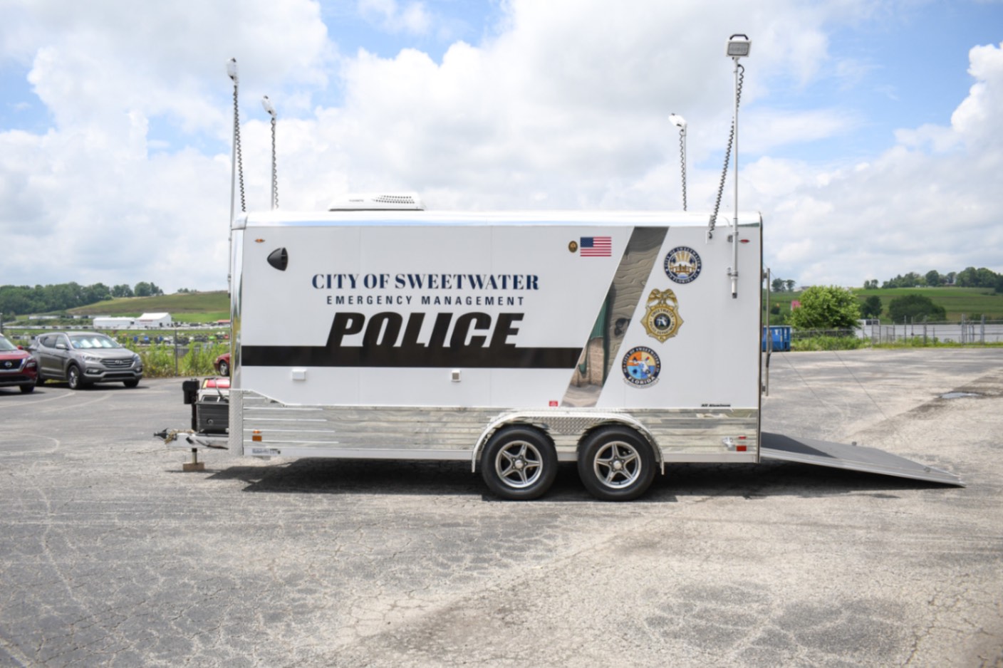 An alternate side view of the Command 20 Cargo Supply trailer made for Sweetwater, FL. The push-up pole lights are up.