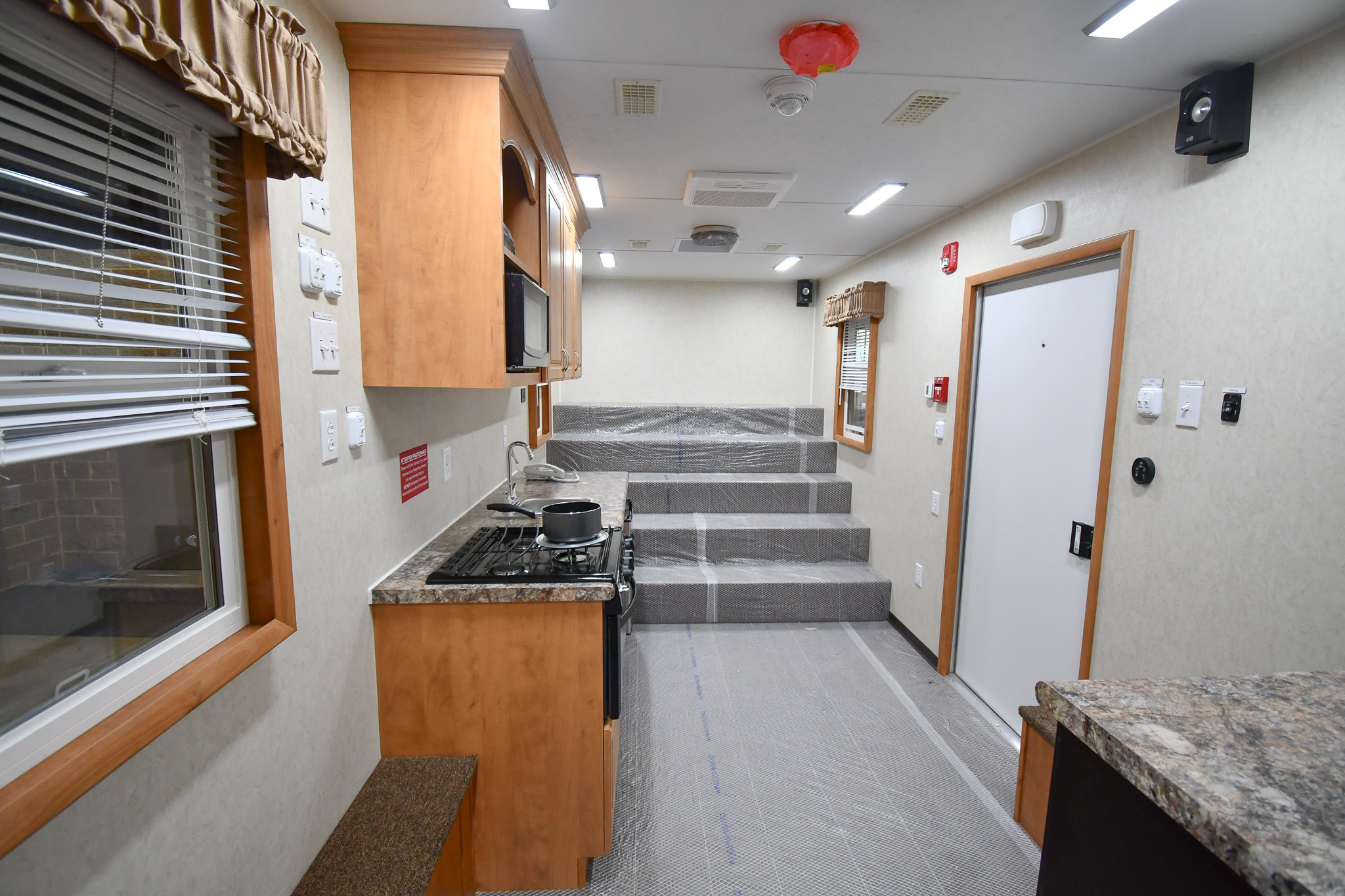 A front-to-back view from the doorway to the bedroom stage inside the unit for Lancaster, TX.