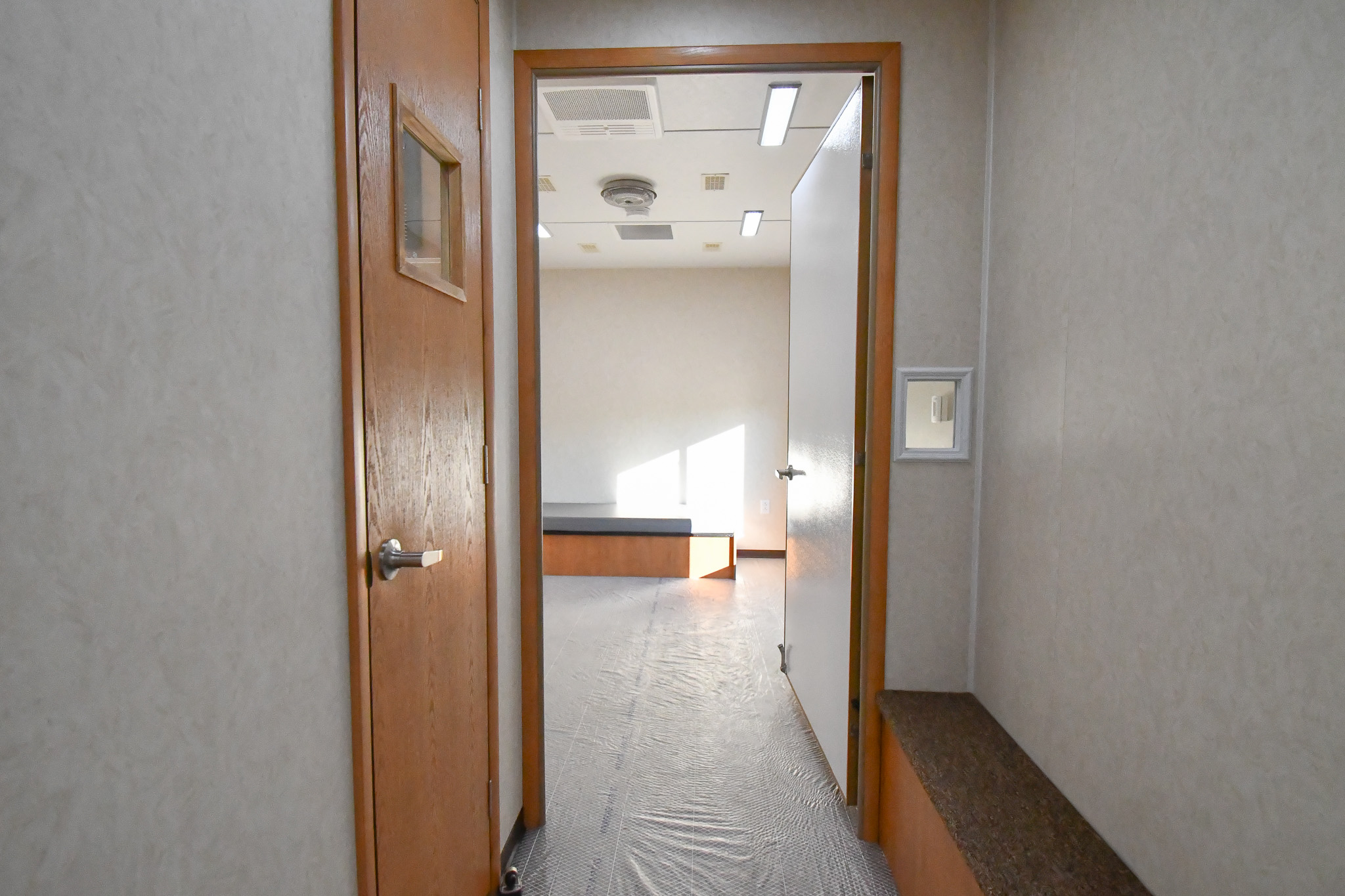 The hallway between the two bedroom stages inside the unit for Wantagh, NY.