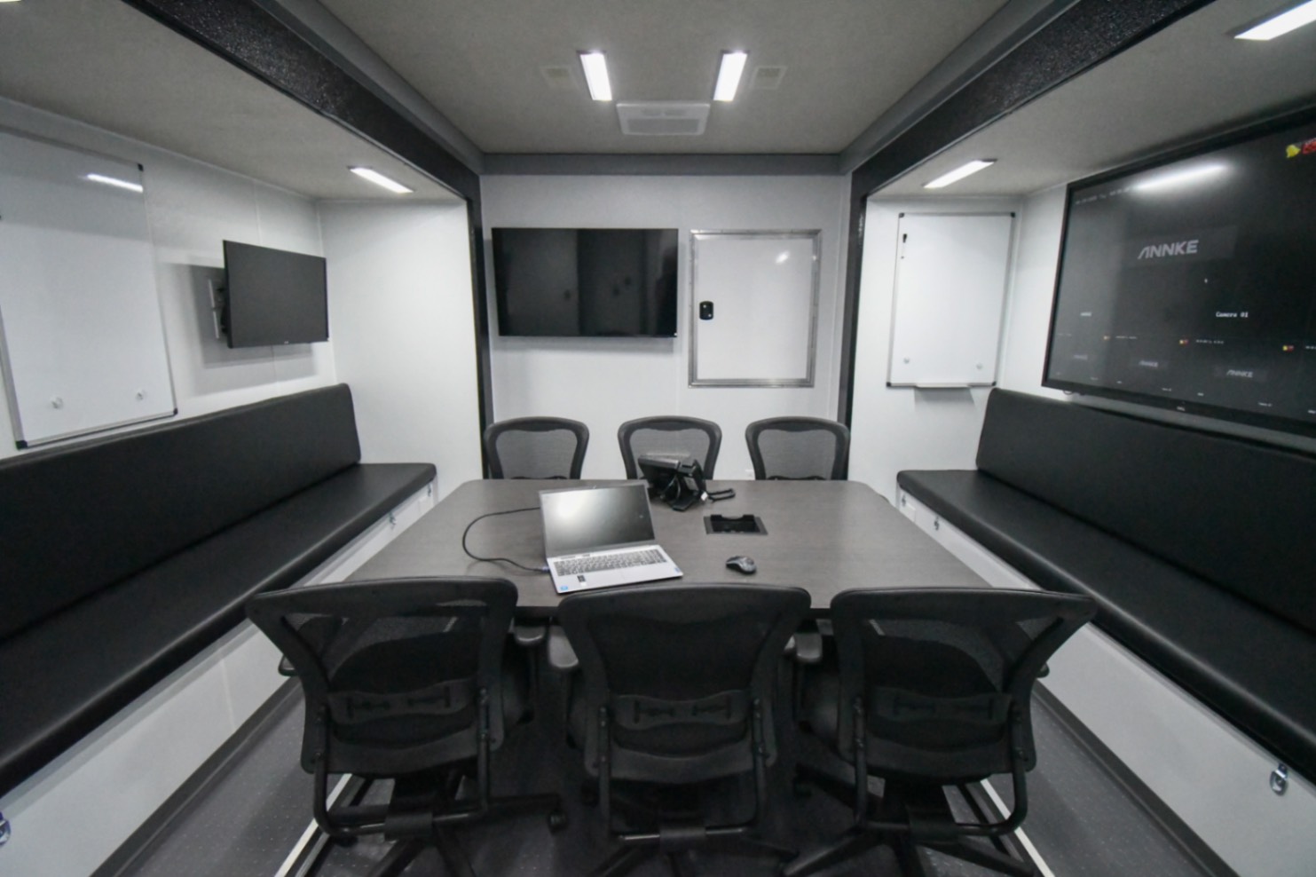 The conference room inside the Command 42-5WS FW 2SO made for Sweetwater, FL. The door to the fifth wheel storage space is closed.