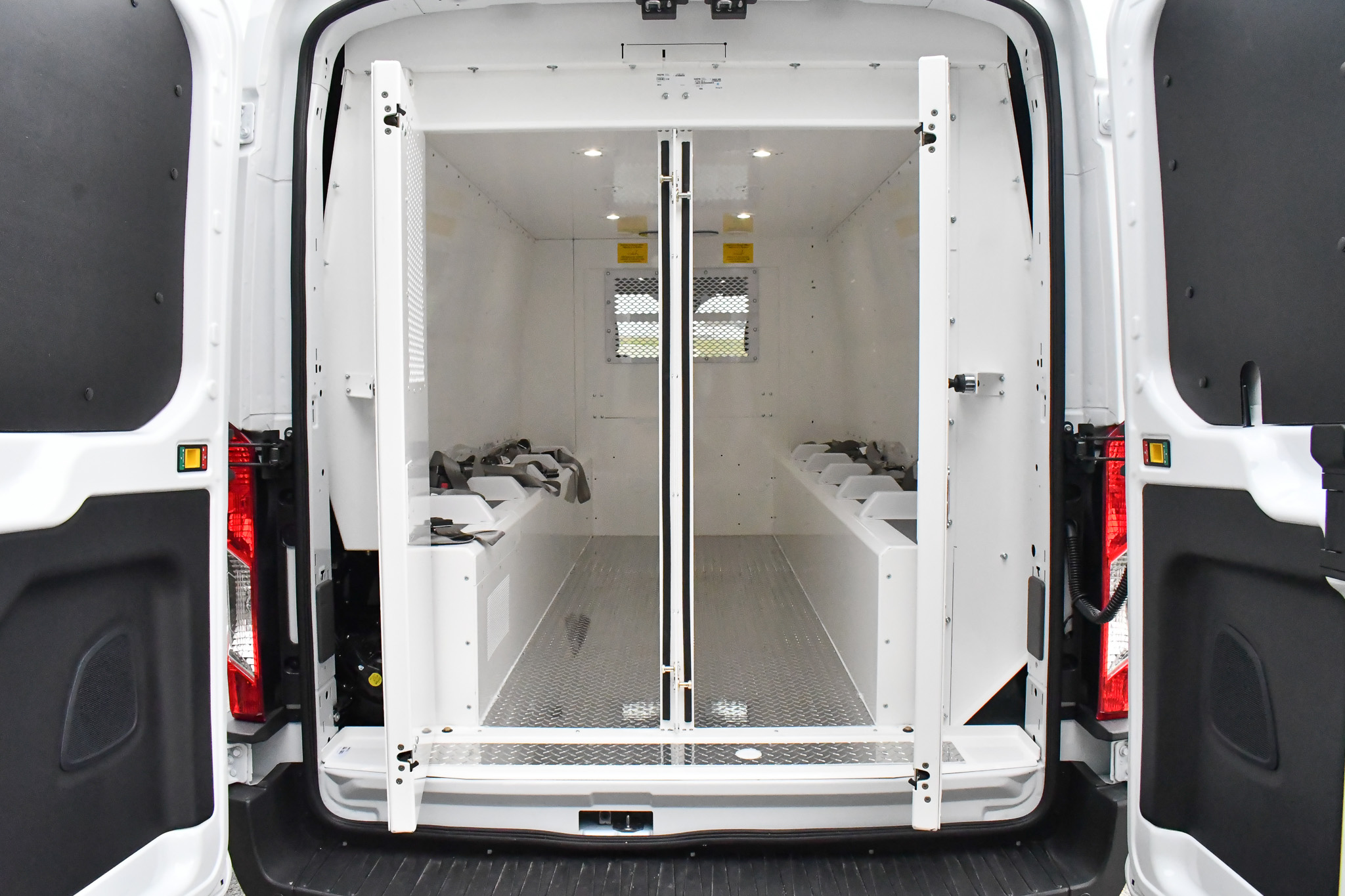 An exterior view of the Prisoner Transit vans' interior. Both sets of doors are open.
