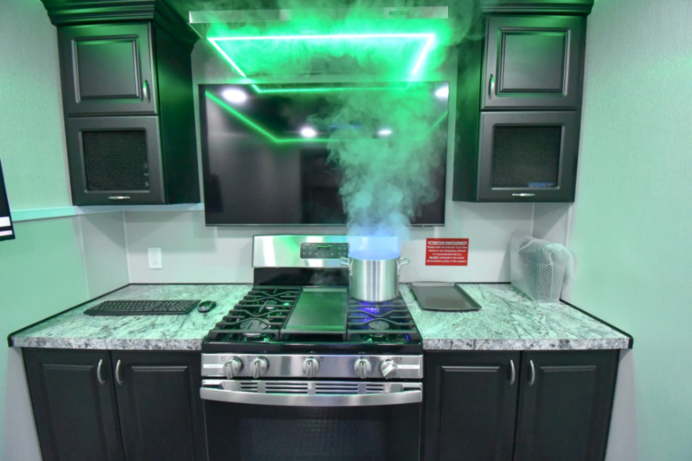 The kitchen stage inside the 35-Classroom made for Carolina, PR. The stovetop simulation is active and smoking.