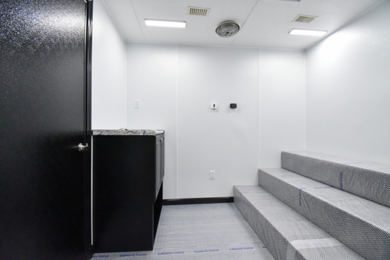 The first room inside the 31Bleacher Mod made for Burien, WA. The door to the hallway is closed.