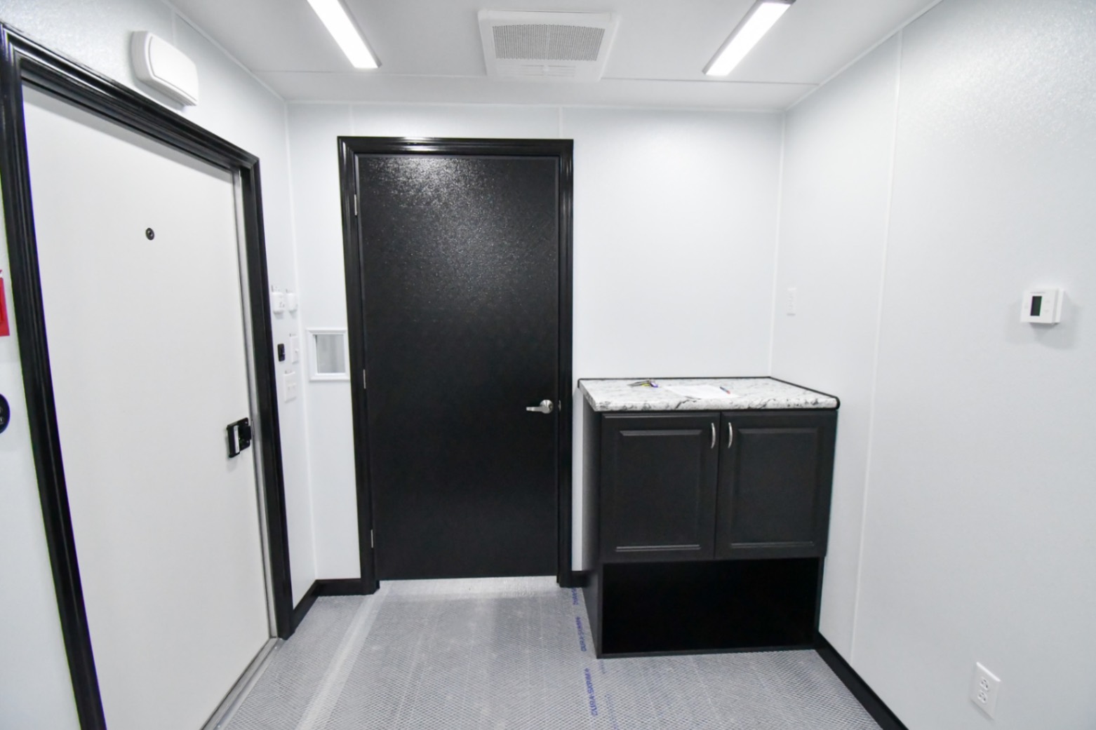 A front-to-back view inside the 31Bleacher Mod made for Burien, WA. The door to the hallway is closed.