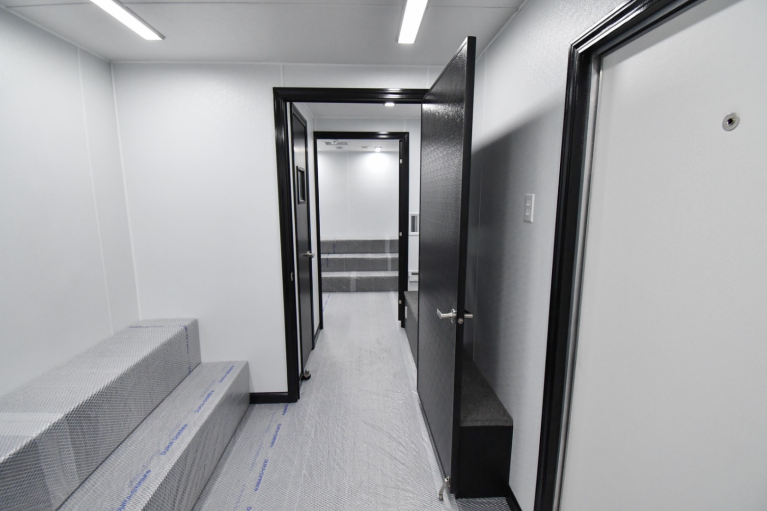 A back-to-front view inside the 31Bleacher Mod made for Burien, WA. The door to the hallway is open.